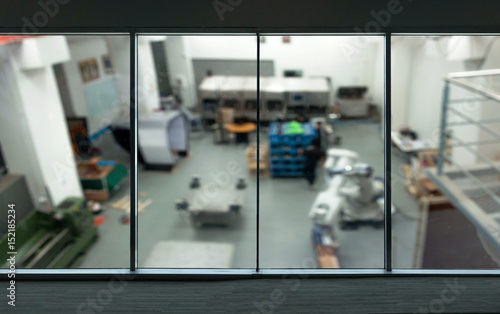 Industrial 4.0 Cyber Physical Systems concept. Window in smart factory with blur background.