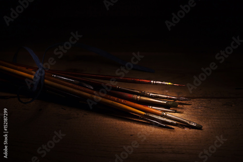 painting brushes over wooden background