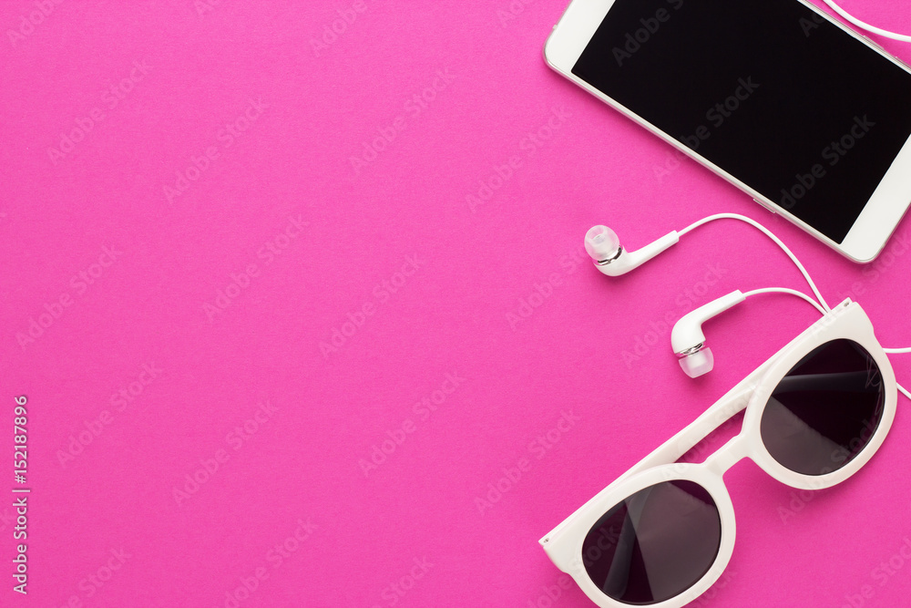 studio shot of white sunglasses smart phone and earbuds on magenta background - obrazy, fototapety, plakaty 