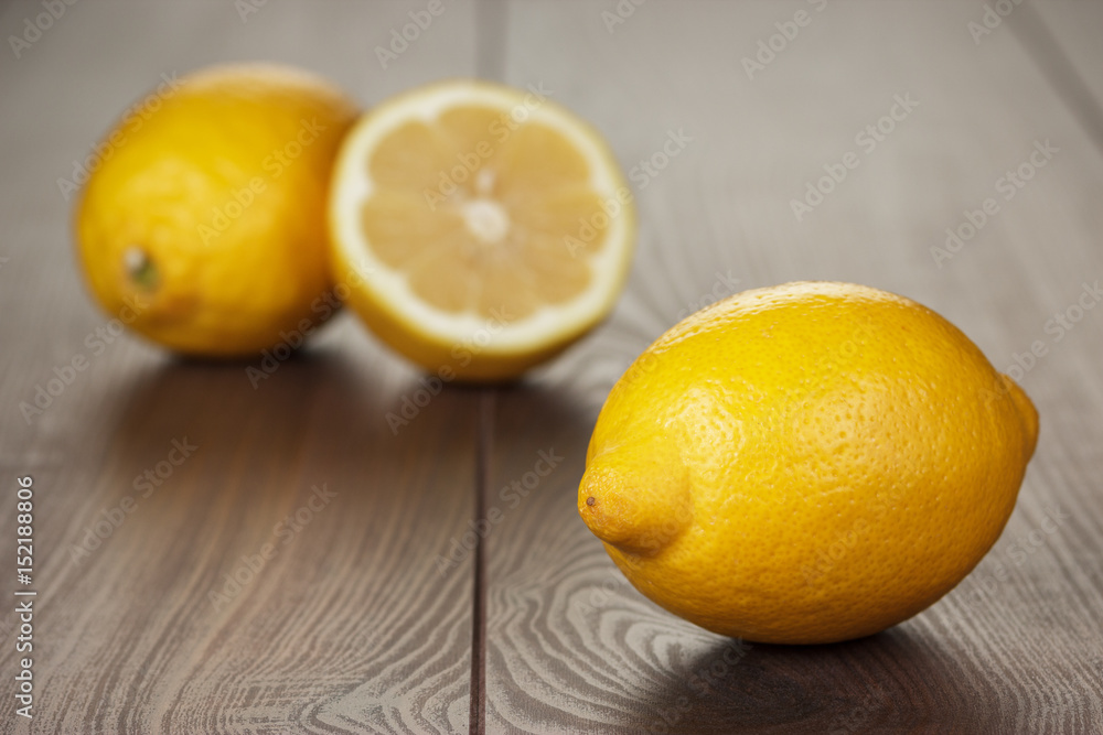 fresh lemons on the brown wooden table