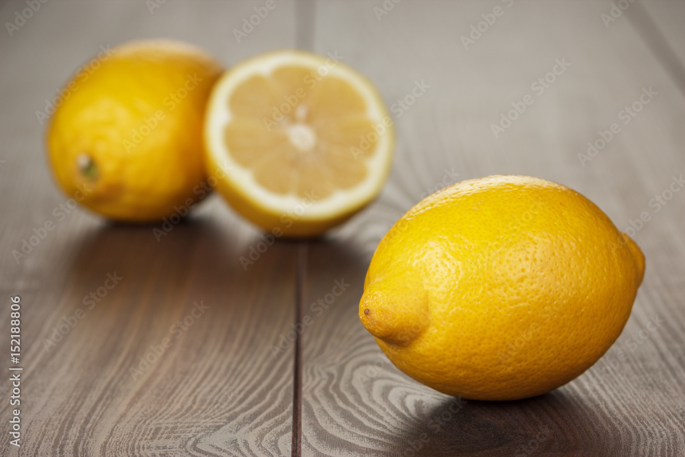 fresh lemons on the brown wooden table fresh lemons on the brown wooden table