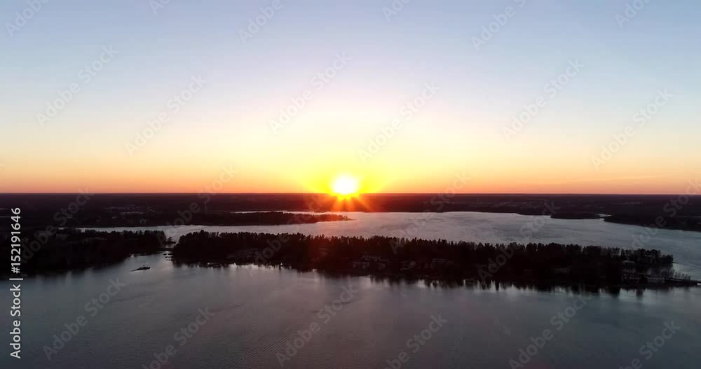 Kuusisaari, Cinema 4k aerial sideway view of a sunset above grano and laajalahti, on a sunny spring evening, in Uusimaa, Finland Kuusisaari, Cinema 4k aerial sideway view of a sunset above grano and laajalahti, on a sunny spring evening, in Uusimaa, Finland