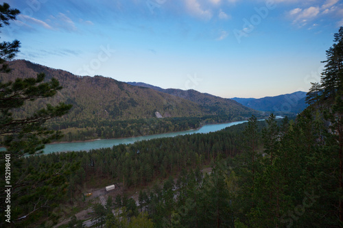 Fototapeta Naklejka Na Ścianę i Meble -  The river flows between the mountains covered with forest on the Altai 