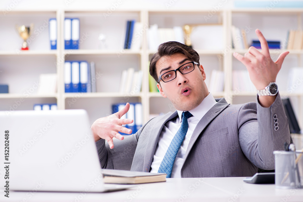 Businessman playing virtual guitar in office Businessman playing virtual guitar in office