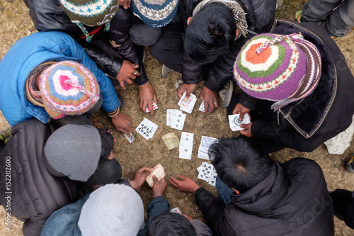 Sherpas are enjoying moments of card game in late afternoon in Himalaya, Nepal photo