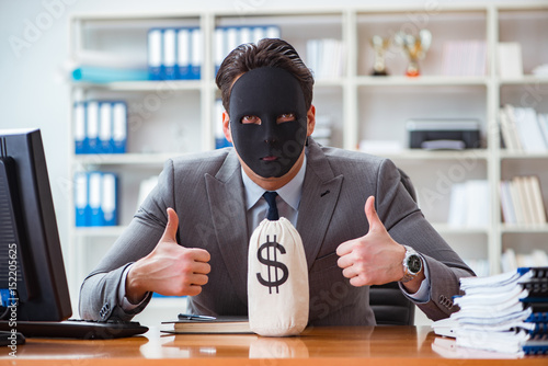 Businessman with mask in office hypocrisy concept