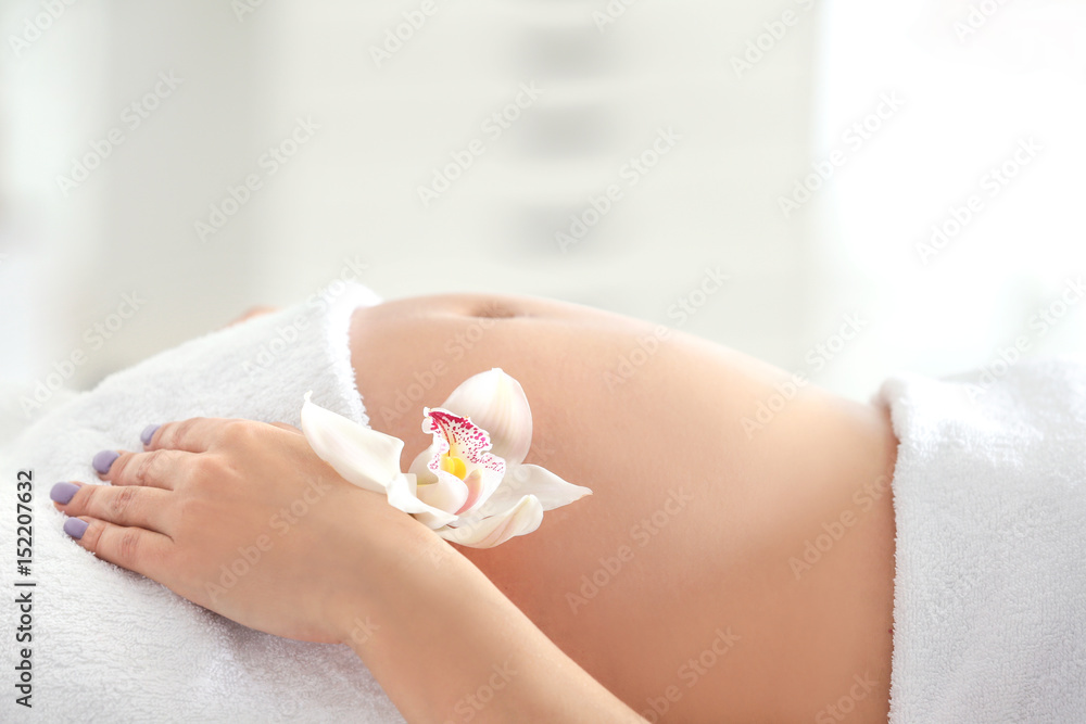 Young beautiful pregnant woman relaxing in spa salon