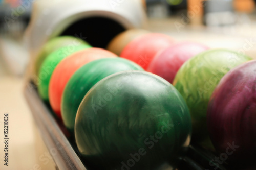 Colorful balls on rack in bowling club  closeup