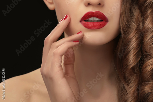 Beautiful young woman on dark background  closeup