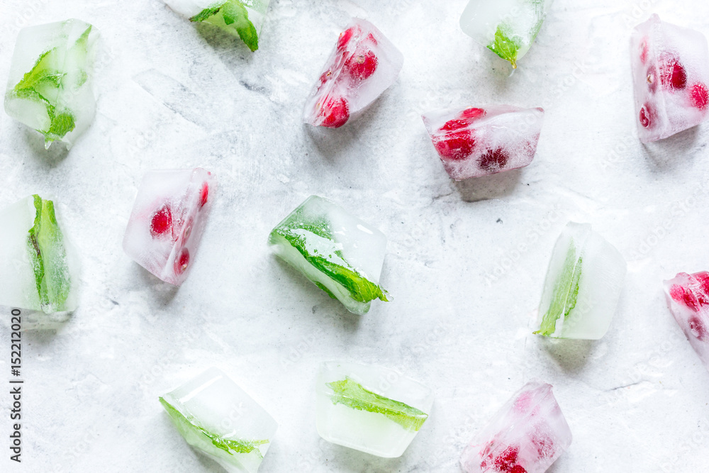 frozen red berries in ice cubes on stone background top view frozen red berries in ice cubes on stone background top view