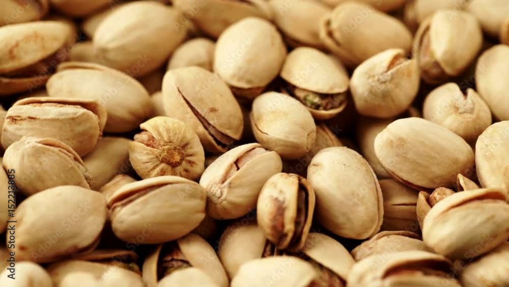 Food background. Roasted pistachio nuts seed with shell close up. Dieting concept. Dolly slider shot 4K ProRes HQ codec Food background. Roasted pistachio nuts seed with shell close up. Dieting concept. Dolly slider shot 4K ProRes HQ codec