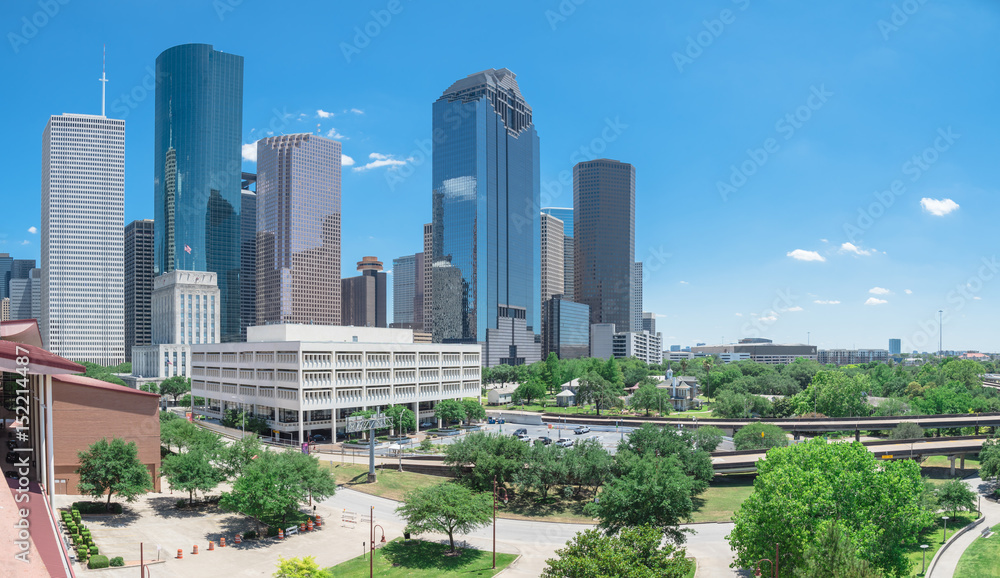 Panorama aerial view downtown Houston next to I-45 freeway during daytime, cloud blue sky. The most populous city in Texas and the fourth-most in United States. Transportation, architecture background