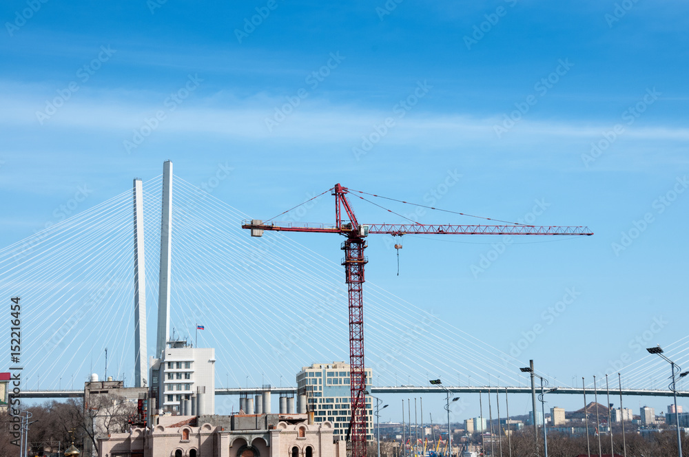 Tower crane near the bridge, the city of Vladivostok