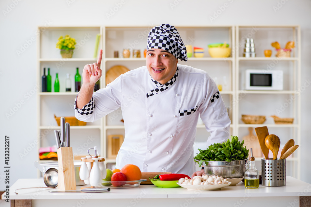 Young male cook working in the kitchen Young male cook working in the kitchen