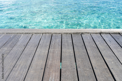 Wooden floor with seascape background