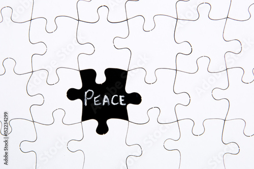 Puzzle Pieces - with word Peace in black chalkboard space
