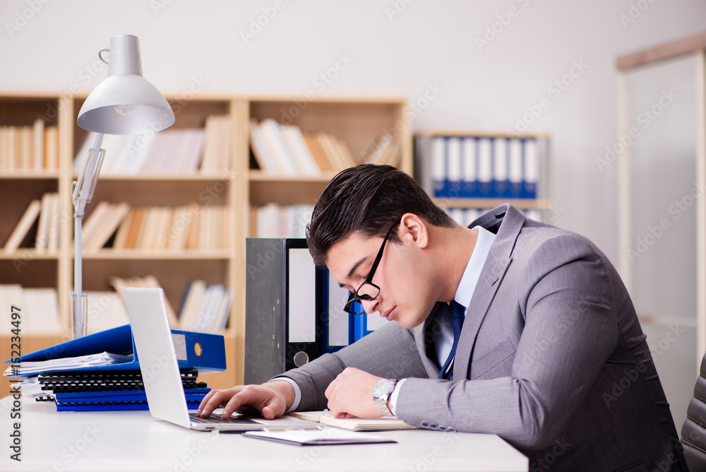 Tired businessman working in the office Tired businessman working in the office