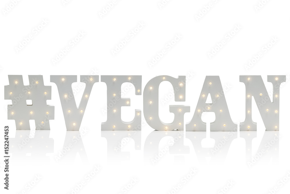 Illuminated Decorative Letters Spelling #VEGAN Over White Background