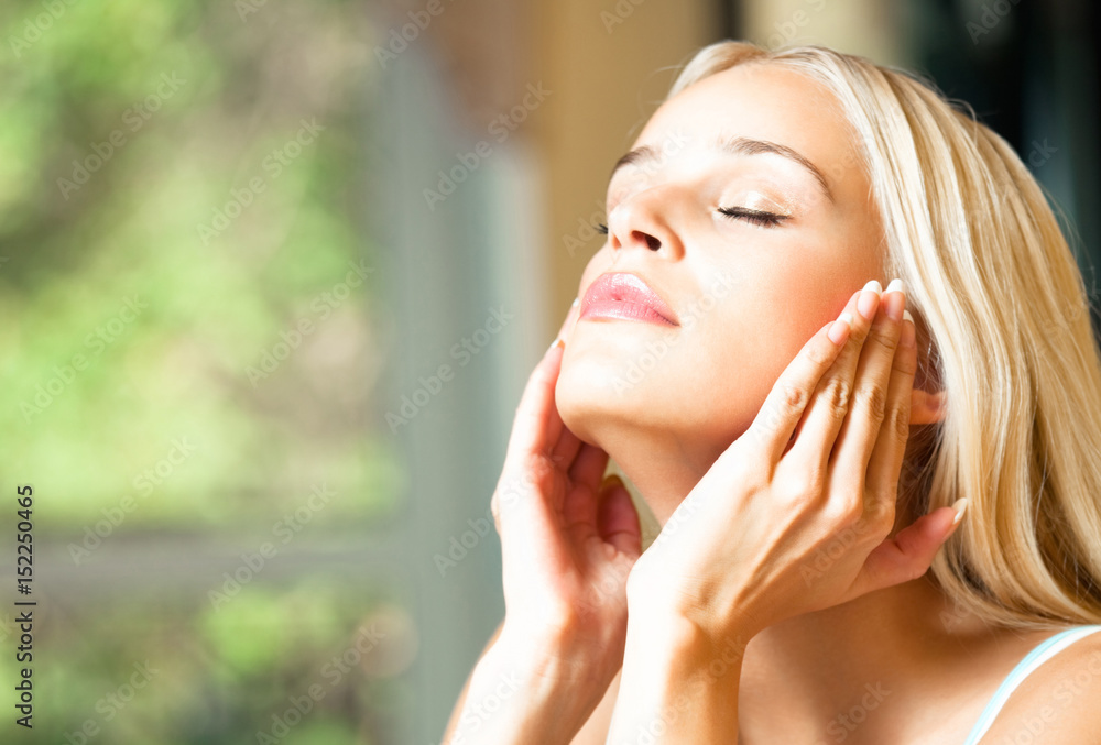 Happy smiling woman applying creme, indoor Happy smiling woman applying creme, indoor
