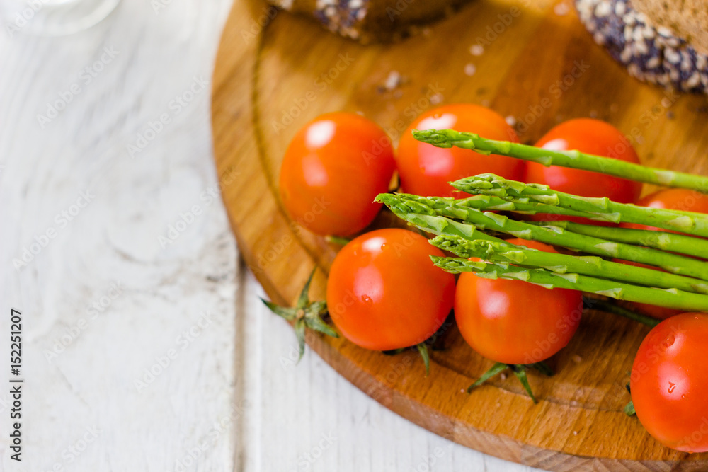 Fresh asparagus, bread and tomatoes Fresh asparagus, bread and tomatoes