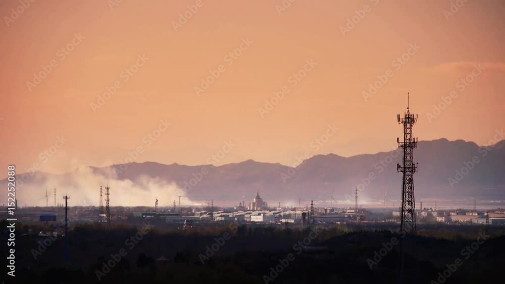 Panoramic of city town & factory smoke rely on mountain,Tower on hill at dusk. Panoramic of city town & factory smoke rely on mountain,Tower on hill at dusk.