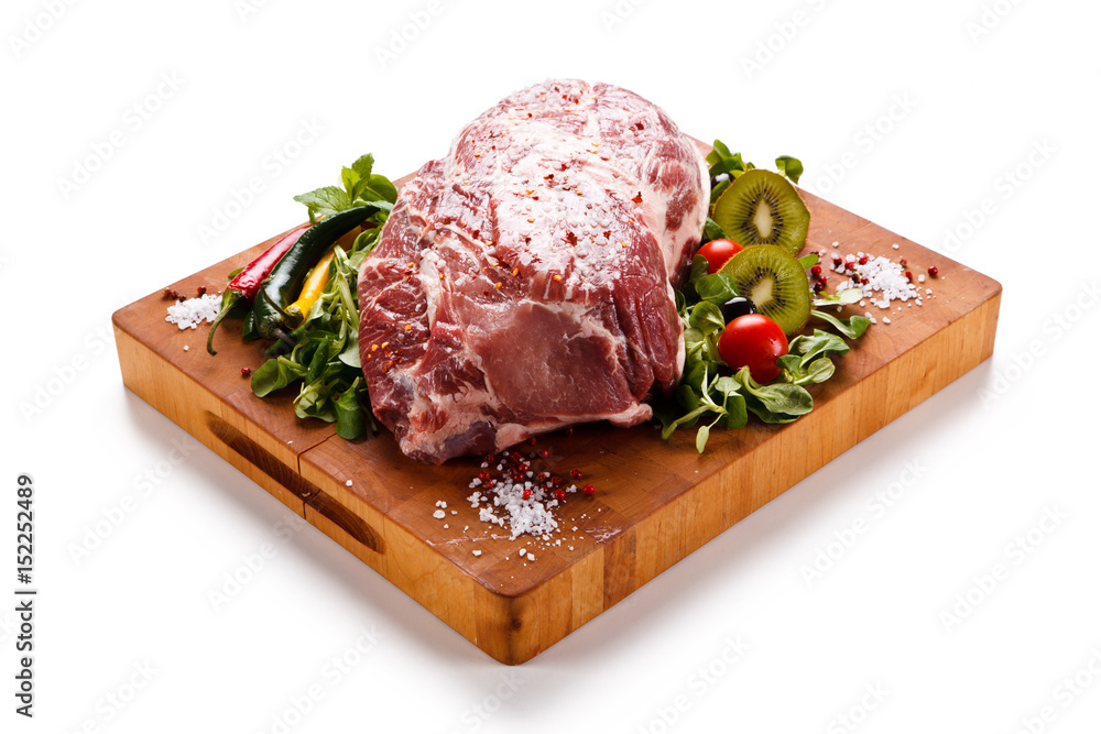 Fototapeta premium Fresh raw pork on cutting board on white background