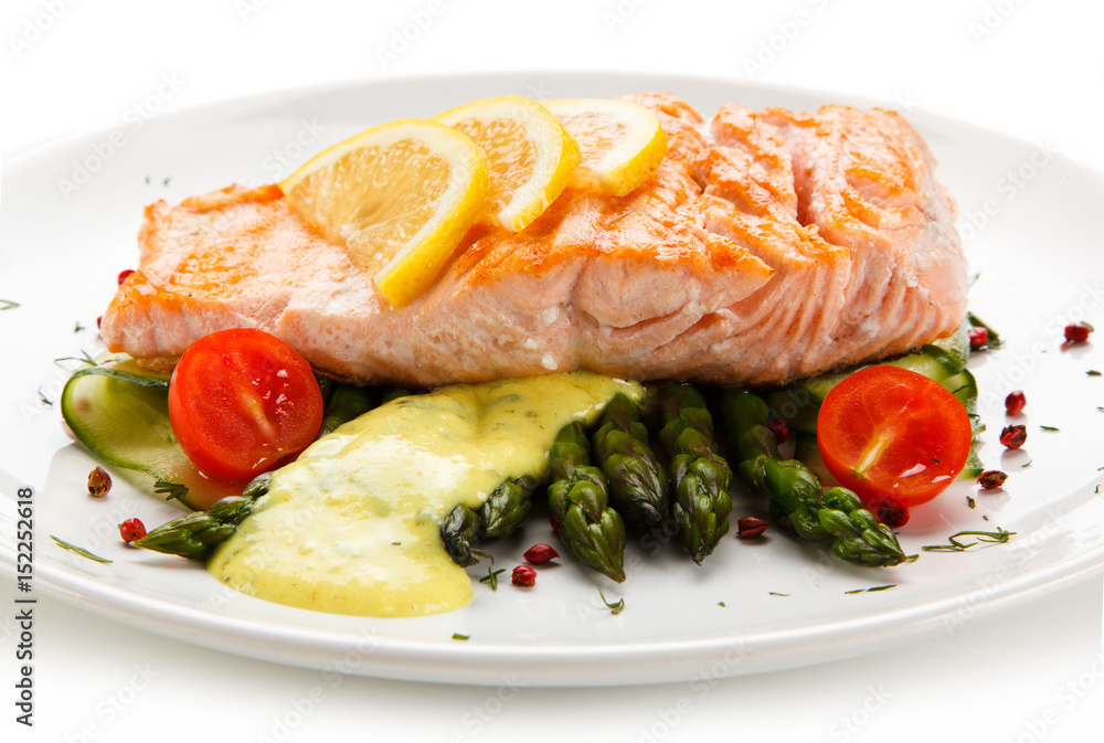 Grilled salmon with asparagus on white background
