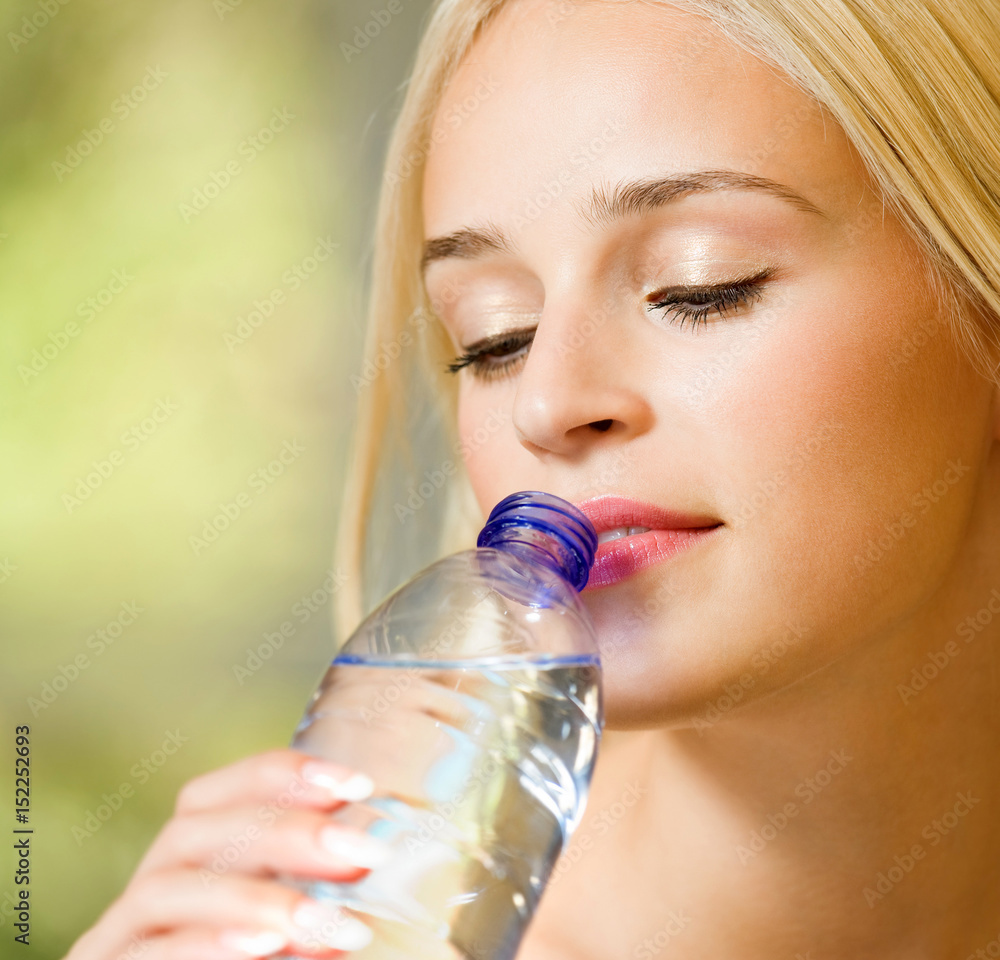 Young beautiful blond woman drinking water Young beautiful blond woman drinking water
