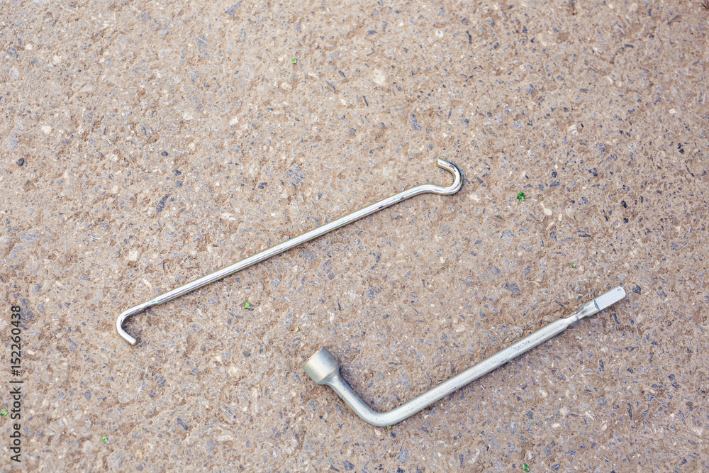 Metal screwdrivers for tyre fitting on asphalt background. Metal screwdrivers for tyre fitting on asphalt background.