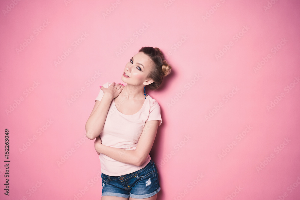 close-up portrait of young beautiful slim sexy young blonde woman in a retro pin-up style on pink background in studio wearing sunglasses smiling and posing close-up portrait of young beautiful slim sexy young blonde woman in a retro pin-up style on pink background in studio wearing sunglasses smiling and posing