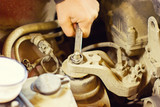 the mechanic of the hood of a car repair