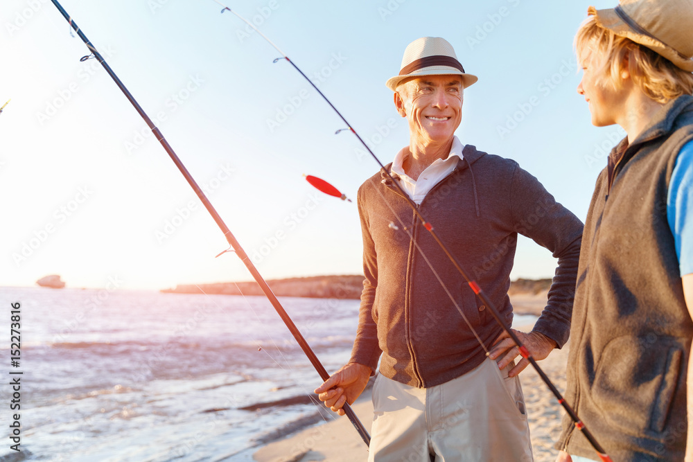 Senior man fishing with his grandson Senior man fishing with his grandson