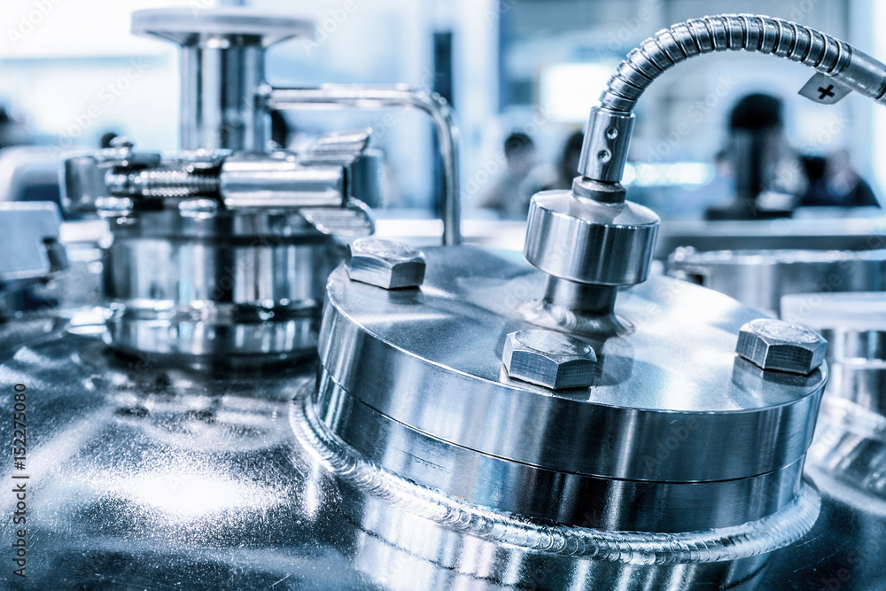 Metal flanges with flexible nipples, chemical reactor body, selective focus. Metal flanges with flexible nipples, chemical reactor body, selective focus.