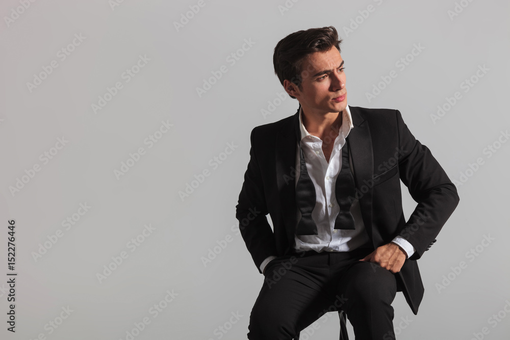 elegant fashion model sitting and looks to side elegant fashion model sitting and looks to side