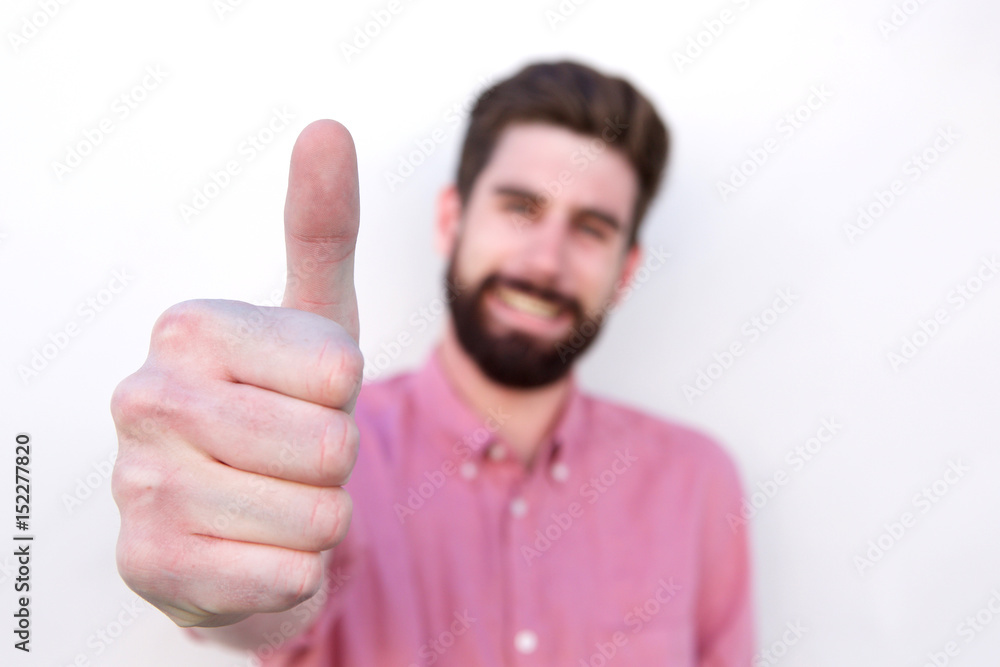 Close up smiling positive man with thumb up Close up smiling positive man with thumb up