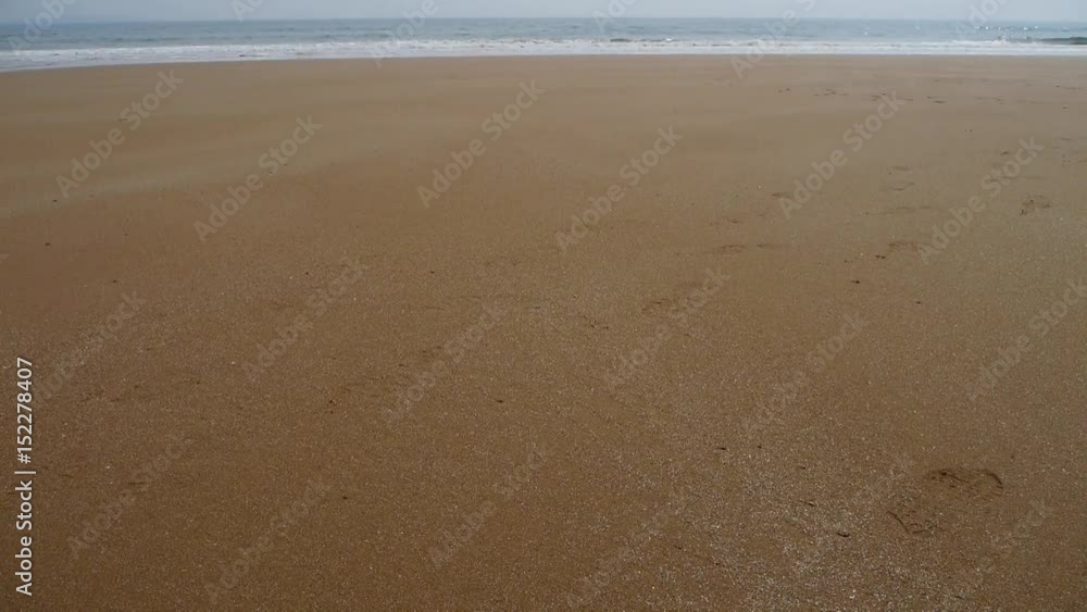 Ocean waves on the golden beach.	