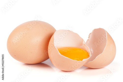 one brown egg and broken egg isolated on white background