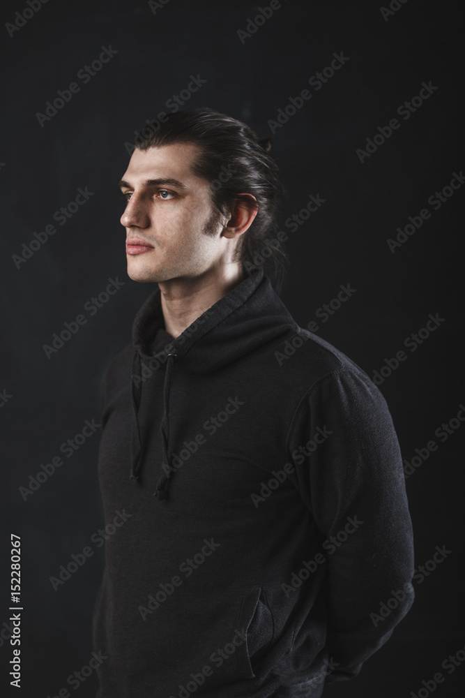 handsome guy on dark background in studio handsome guy on dark background in studio