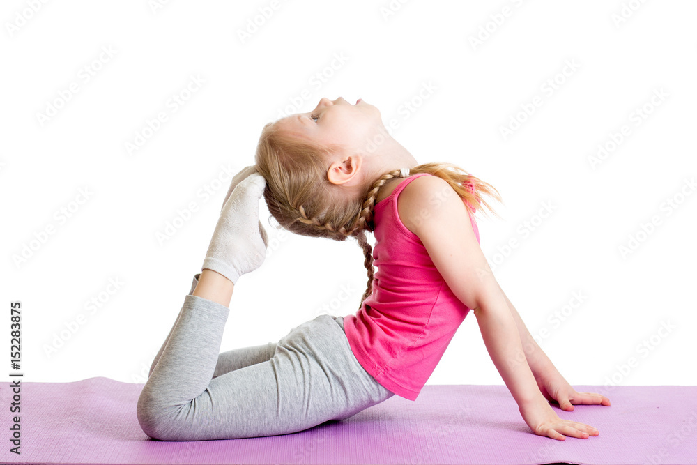 Kid doing fitness exercises on mat. Isolated on white. Kid doing fitness exercises on mat. Isolated on white.