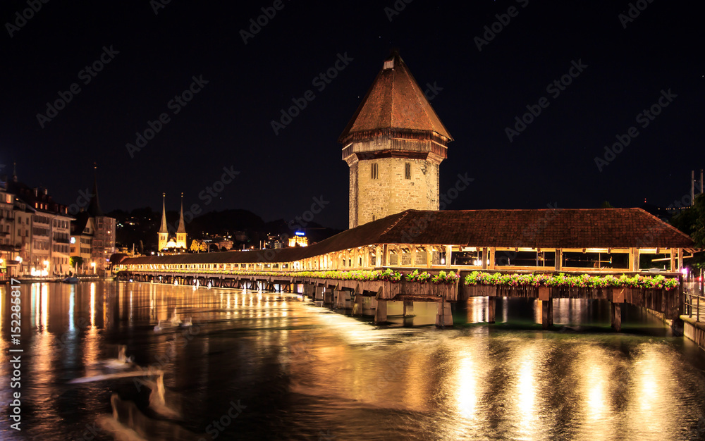Chapel Bridge and Water Tower at night with reflection on the lake, Lucerne, Switzerland Chapel Bridge and Water Tower at night with reflection on the lake, Lucerne, Switzerland