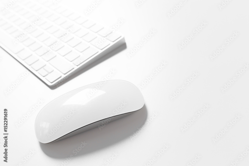 Computer keyboard and mouse on top of white desktop Computer keyboard and mouse on top of white desktop