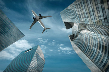 Airlane flying over modern glass and steel office buildings near