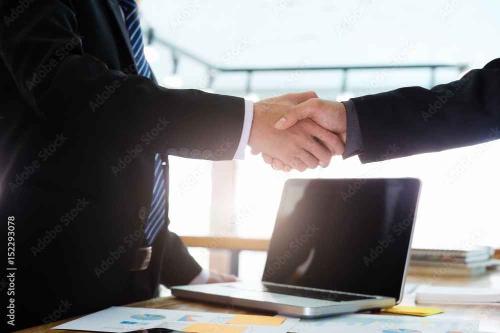 Successful businessmen handshaking after good deal.