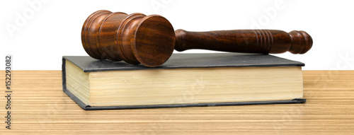 Wooden gavel and books on wooden table