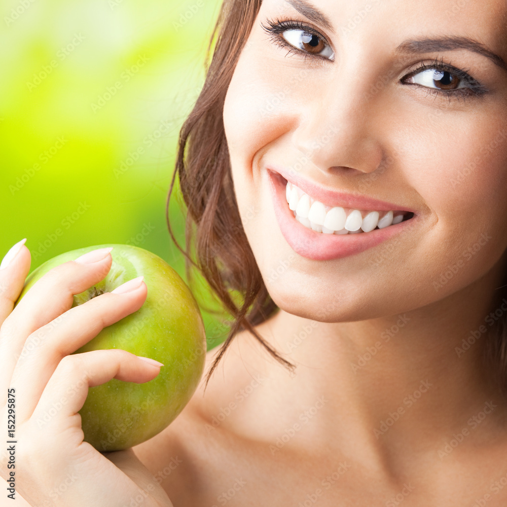 Young happy smiling woman with apple, outdoors Young happy smiling woman with apple, outdoors