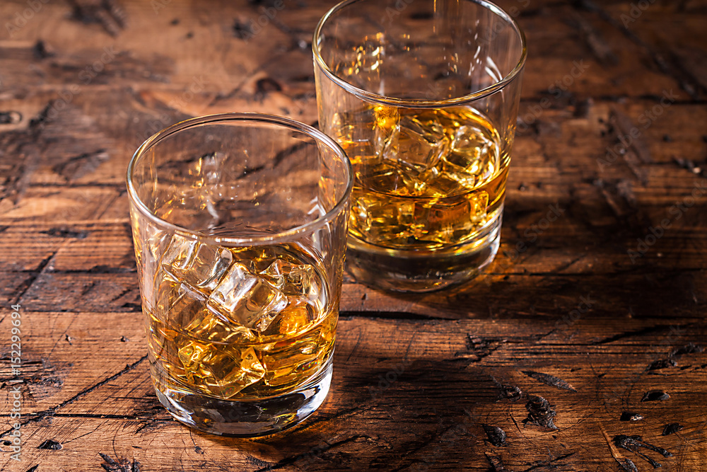 Whiskey with ice in glasses Whiskey with ice in glasses
