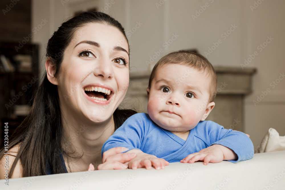 Mother with son spending time together and laughing at camera Mother with son spending time together and laughing at camera