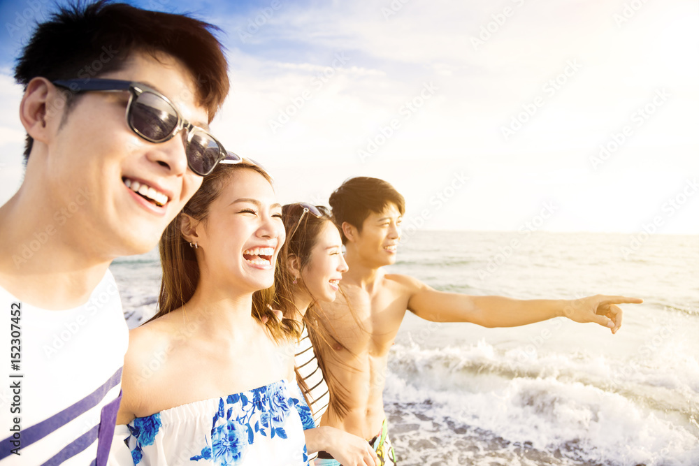 happy young group walking on the beach enjoy summer vacation