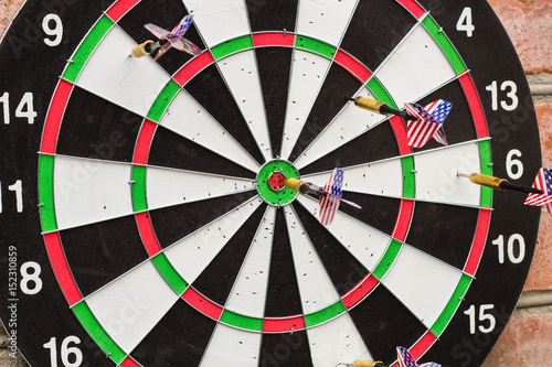 dart in bullseye on the target with many other Darts
