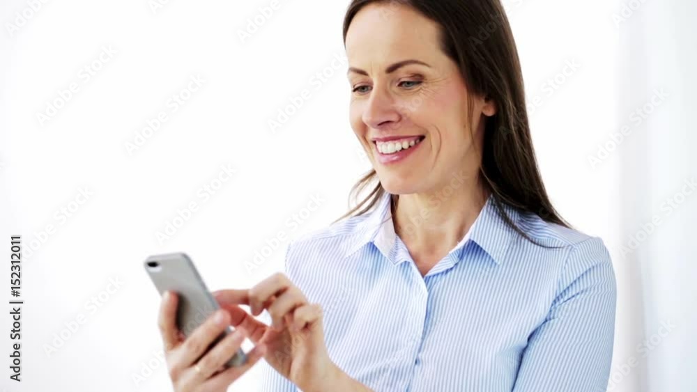 happy businesswoman with smartphone at office happy businesswoman with smartphone at office